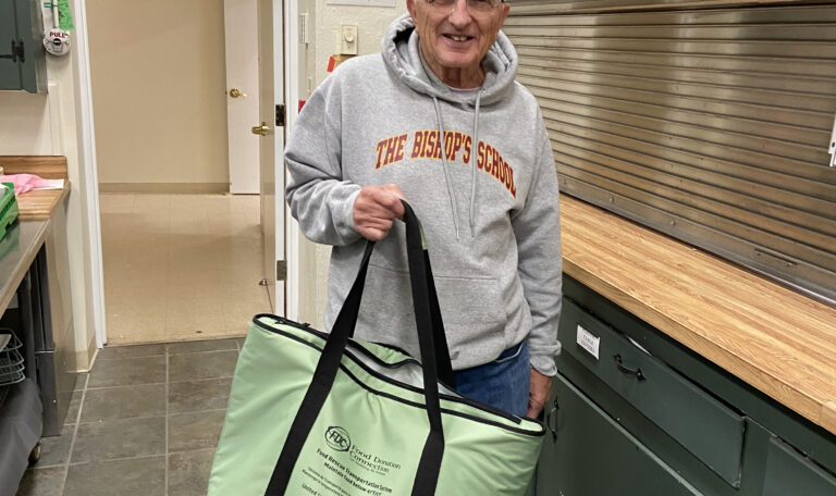 Bill Sweeney, vestry member and parishioner at Grace Haddonfield, with a bag of Wawa food ready for delivery
